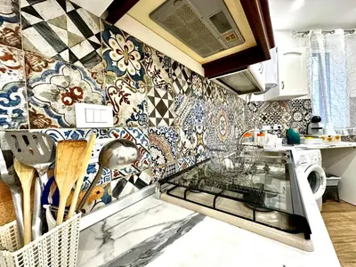 a kitchen with colorful tiles on the wall at MD APARTAMENT CORAL BAHLARA in Palermo