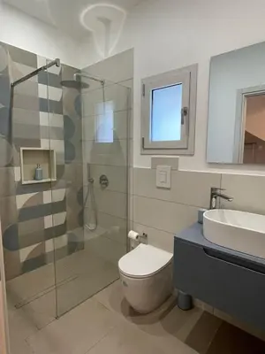 a bathroom with a shower and a toilet and a sink at Summer Vibes in Castellammare del Golfo