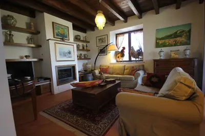 a living room with a couch and a table at Casa Margaret in Collesano