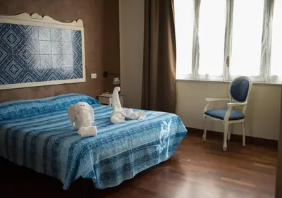a bedroom with a bed with two stuffed animals on it at Stupor Mundi Bed and Breakfast in Palermo