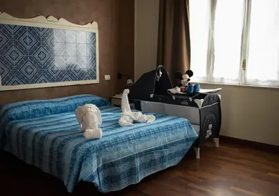 a bedroom with a bed with stuffed animals and a piano at Stupor Mundi Bed and Breakfast in Palermo