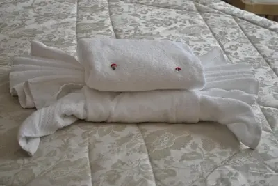 a towel animal is laying on a bed at Stupor Mundi Bed and Breakfast in Palermo