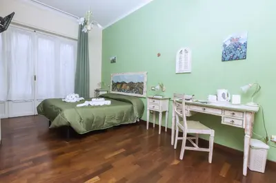 a bedroom with a desk and a bed and a desk and a table and chair at Stupor Mundi Bed and Breakfast in Palermo