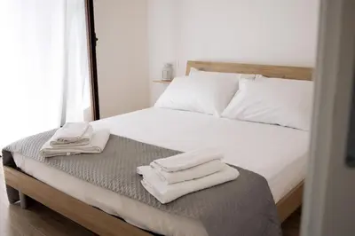 a bedroom with a bed with two towels on it at La Casa al mercato - SELF CHECK-IN in Palermo