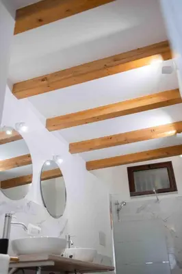 a bathroom with two sinks and a mirror at La Casa al mercato - SELF CHECK-IN in Palermo