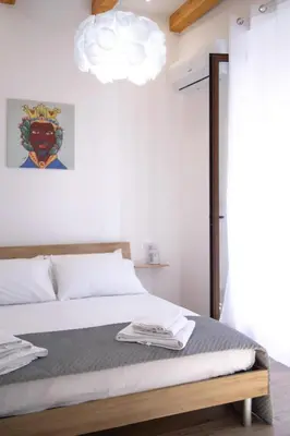 a bedroom with a bed and a pendant light at La Casa al mercato - SELF CHECK-IN in Palermo