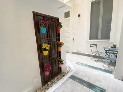 a room with a door with potted plants on it at Kamaffari Central Apartment in Palermo