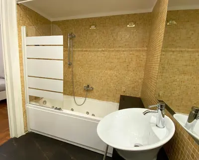 a bathroom with a sink and a shower and a tub at Kamaffari Central Apartment in Palermo