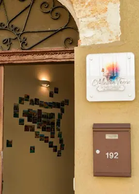 a sign on a wall next to a door with a mailbox at Madre Terra Airport Apartment & Rooms in Terrasini