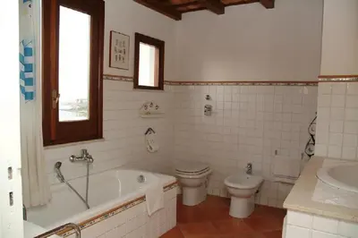 a bathroom with a tub and a toilet and a sink at Punto de Vista B&B Makari in San Vito lo Capo