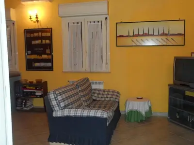 a living room with a couch and a tv at Alle Terrazze del Borgo Vecchio in Palermo