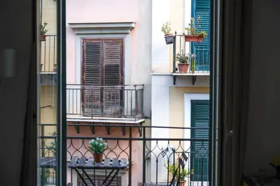 a flower pot sitting on top of a wooden bench at Appartamento nel centro storico di Palermo - Via Meli's House in Palermo