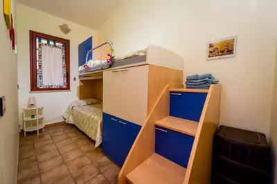 a small room with a bed and a bunk bed at Villa Oasi del Relax Flavianna in Castellammare del Golfo