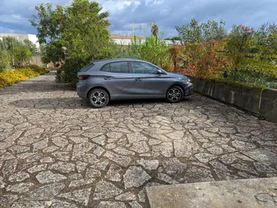 a silver car parked on a stone driveway at Villa Oasi del Relax Flavianna in Castellammare del Golfo