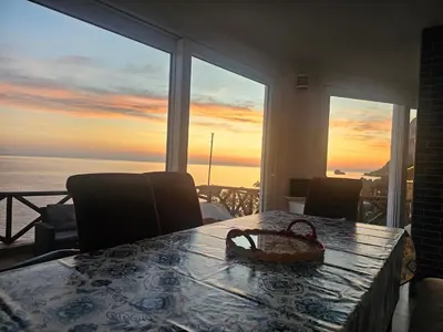 a dining room table with a view of the ocean at Mare e cielo in Porticello