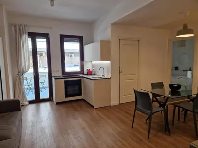 a kitchen and living room with a table and chairs at SPRING APARTMENTS in Palermo