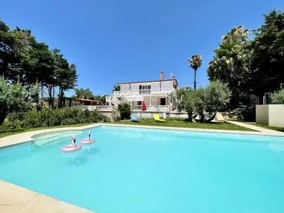 a large swimming pool in front of a house at Villa Rachele con piscina in Balestrate