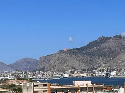 a view of a city with mountains in the background at harriets house in Palermo