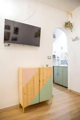 a living room with a tv on a wall at Pilly House Rinascente in Palermo