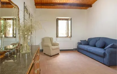 a living room with a blue couch and a chair at Casa San Giovanni in Giuliana