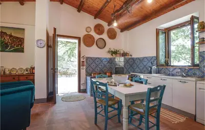 a kitchen with a table and chairs in a room at Casa San Giovanni in Giuliana