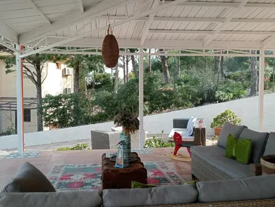 a group of people sitting in chairs on a beach at LE SORELLE entire villa sea view in Scopello