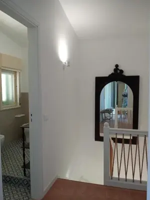 a bedroom with a large bed with white sheets at LE SORELLE entire villa sea view in Scopello