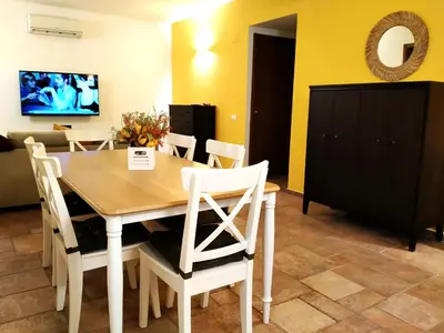 a dining room with a wooden table and chairs at Alvarado - Your Home in Sicily in Carini