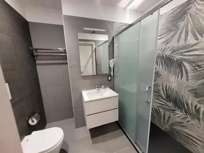 a bathroom with a toilet and a sink and a mirror at SP Rooms in Isola delle Femmine
