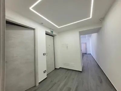 an empty room with a door and a hallway at SP Rooms in Isola delle Femmine