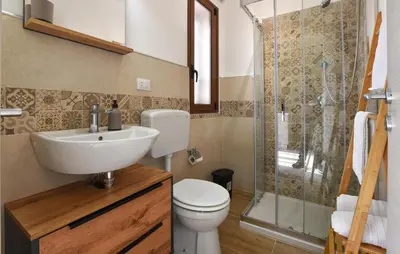 a bathroom with a toilet and a sink and a shower at Lovely Apartment In Trappeto With Wifi in Trappeto