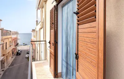 a door to a balcony with a view of the ocean at Lovely Apartment In Trappeto With Wifi in Trappeto