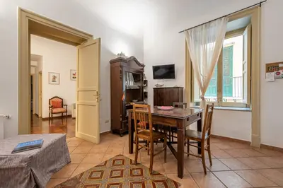 a dining room with a table and chairs in a room at Casa Marettu in Palermo
