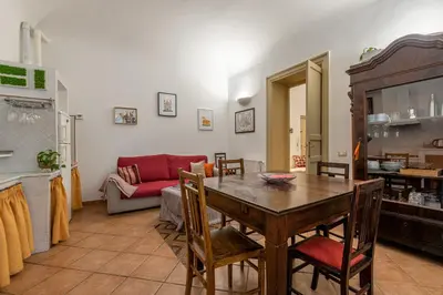 a living room with a table and a couch at Casa Marettu in Palermo