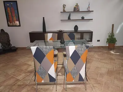 a dining room with a glass table and two chairs at A&C GOLD DIAMOND in Palermo