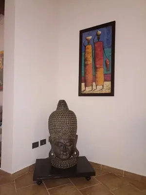 a statue in a room with a painting on the wall at A&C GOLD DIAMOND in Palermo