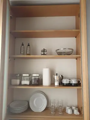 a pantry with plates and dishes on shelves at A&C GOLD DIAMOND in Palermo