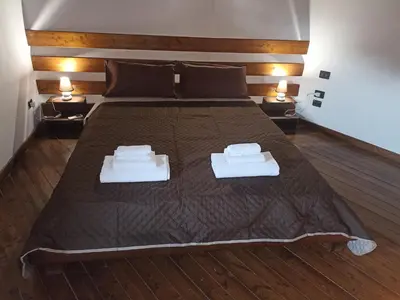 a bedroom with a large bed with two towels on it at A&C GOLD DIAMOND in Palermo