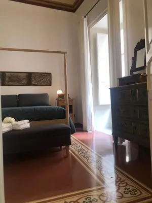 a living room with a couch and a mirror at Casa degli Allori in Palermo
