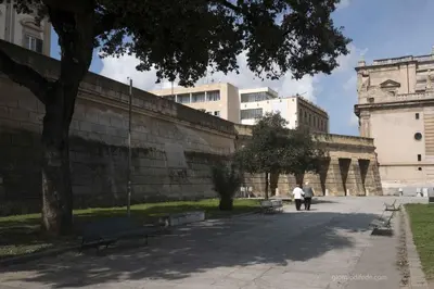 two people walking in front of a large building at Casa degli Allori in Palermo