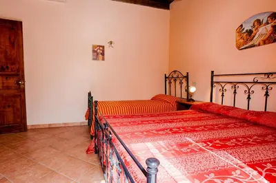 a bedroom with a bed and a couch at GuestHost - Corso Garibaldi - Castellammare Central Flats in Castellammare del Golfo