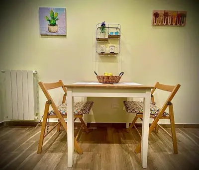 a dining room table with two chairs and a basket on it at Casa Batù alle porte del Capo in Palermo