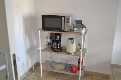 a microwave on a shelf with a coffee maker at 4 Country Side - City Center in Palermo