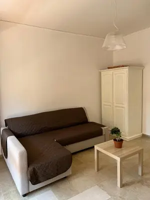a living room with a couch and a table at 4 Country Side - City Center in Palermo
