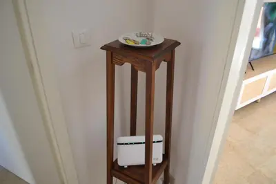 a small wooden table with a plate on top of it at 4 Country Side - City Center in Palermo