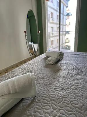 a bed with two rolled towels on top of it at 4 Country Side - City Center in Palermo
