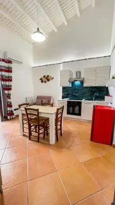 a kitchen and dining room with a table and chairs at Le Case di Romeo in Palermo