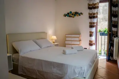 a bedroom with a bed with two pillows on it at Le Case di Romeo in Palermo