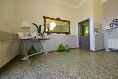 a room with a mirror and a table with green vases at Miss Sicily B&B in Terrasini