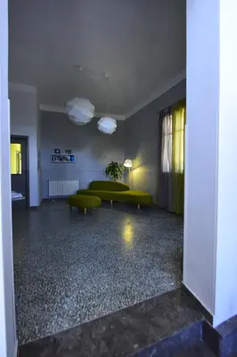 a living room with a green couch and a table at Miss Sicily B&B in Terrasini